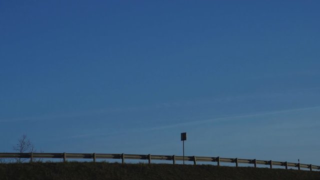 A truck carries cargo on a country road. Against the blue sky, copy space, logistics and freight