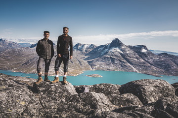 Two young man happy traveler on top of mountain in Greenland, Nuuk. nature mountain landscape aerial drone photo showing amazing greenland landscape near Nuup Kangerlua fjord seen from Ukkusissat © Mathias