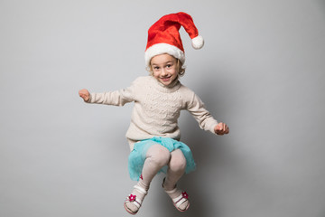 Smiling girl in the winter look on the grey
