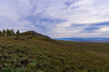 Fototapeta premium Hills. Sky. The clouds. Steppe. The trees.