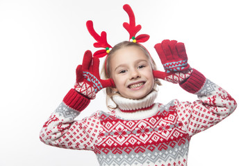 Cute young girl wearing deer horns. New year concept.