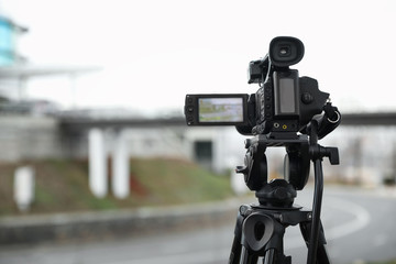 Professional video camera outdoors. Space for text