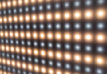 Defocused close-up of panel with bright luminous LEDs
