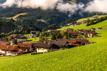 Fototapeta na wymiar Guesthouse and farmhouse under the mountains in Tirol, Austria.