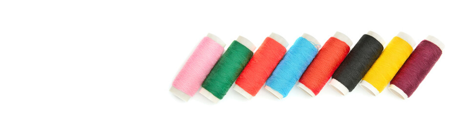 Set of colored thread coils isolated on white background. Free space for text. Wide photo .