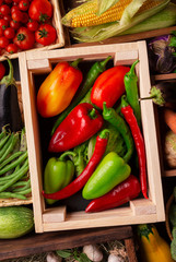Bright and fresh organic vegetables on counter in wooden boxes
