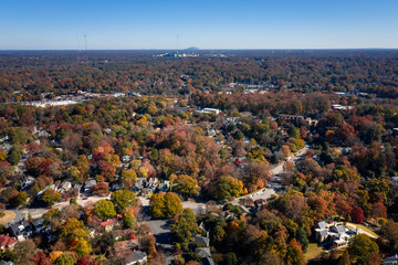 Aerial picture of houses in Midtown Atlanta during the fall and Stone Mountain in the background