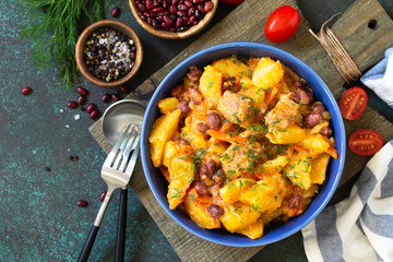 Thanksgiving Autumn Menu. Stew with beans and vegetables in a bowl on a rustic table. Top view of a flat lay with copy space. Copy space.