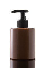 Brown bottle of liquid soap or gel on a white isolated background. Chocolate bottle of intimate soap on a glass surface.