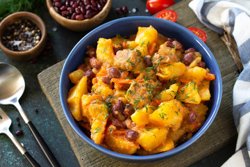 Thanksgiving Autumn Menu. Stew with beans and vegetables in a bowl on a rustic table.