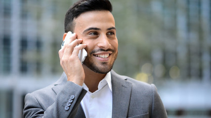 Portrait of a young businessman talking on the phone