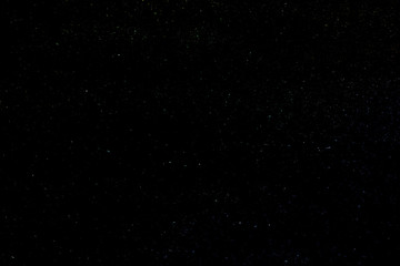 Background of the night clear sky with luminous multi-colored stars.