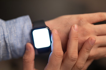 Close up of Businessman's hand looking at hand watch