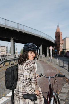 Portrait of woman with a bicycle in the city, Berlin, Germany