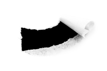 Hole in white paper with torn edges isolated on a white background with a black isolated background inside.