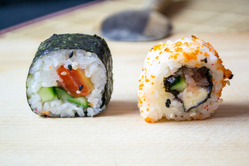 red fish sushi on a wooden tray
