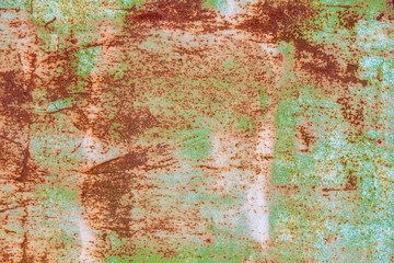 Sheet of old rusty iron with the remains of green paint, background