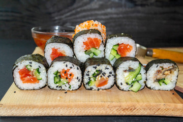 red fish sushi on a wooden tray