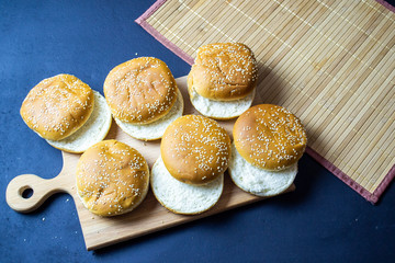 hamburger on a wooden tray on a dark background