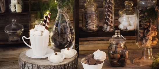 Christmas decoration cocoa bar with cookies and sweets on old wooden background in  natural rustic style. Winter cozy concept