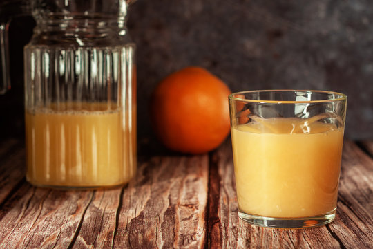 Two glasses of refreshing orange juice on a wooden table