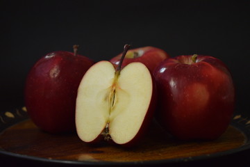 Red Apples Whole And Cut On Wooden Plate