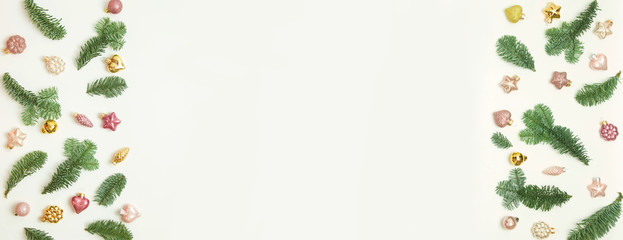 Christmas or New Year background: fir tree branches, glass balls, decoration and cones on a white background