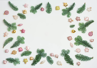 Christmas or New Year background: fir tree branches, glass balls, decoration and cones on a white background