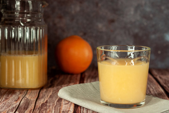 Two glasses of refreshing orange juice on a wooden table