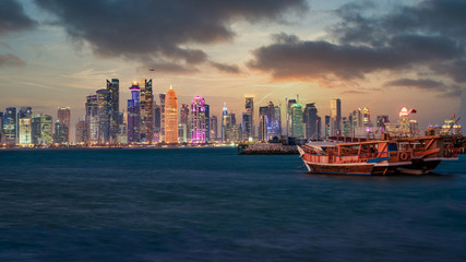 Doha Qatar skyline with traditional Qatari Dhow boats in the harbor
