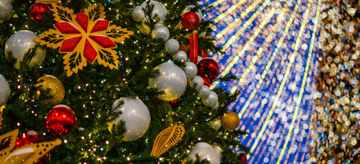 Christmas tree with lights decorations outdoors at night. New Year Celebration. Luxury decorated in european city street at winter seasonal holidays.