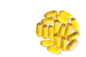 Group of yellow vitamin capsules on white background