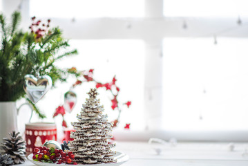 Christmas or new year still life with ornaments on rustic white table. Christmas cookies with festive decoration. Homemade gingerbread. Winter decoration background. Copy space for text.