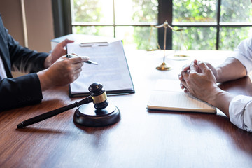 Male lawyer discussing negotiation legal case with client meeting with document contact in...