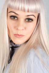 Portrait of a beautiful woman with long blond hair. Shooting in the Studio.