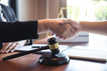 Handshake after good deal negotiation cooperation, Professional male lawyer or counselor and client meeting, working with legal case document contract in office, law and justice, attorney, lawsuit