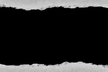 Old vintage paper with torn edges and a black isolated background inside.