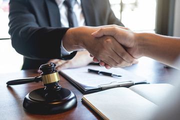 Handshake after good deal negotiation cooperation, Professional male lawyer or counselor and client meeting, working with legal case document contract in office, law and justice, attorney, lawsuit