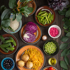 Vegetarian products and dishes on a wooden table.
