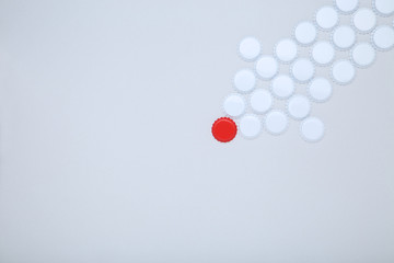 Bottle caps leader on grey background