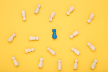 Leader concept. Wooden figures on yellow background
