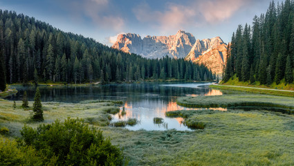 Amazing Colorful Nature Landscape. Wonderful Misty Morning at Misurina Lake during Sunrise. Sunny morning scene of National Park Tre Cime di Lavaredo, Auronzo, Dolomite Alps, Fairytale Woodland