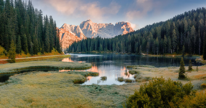 Awesome alpine highlands during sunset. Scenic image of fairy-tale Landscape in sunlit with Majestic Rock Mountain on background. Wild area. Misurina lake. Italy. Dolomites Alps.  Instagram Filter