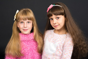 Shooting in the Studio, two girls stand together