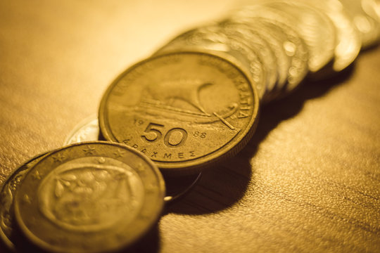 Old drachma coins on the table close-up.