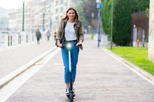 Young woman with e-scooter in Verona, Italy