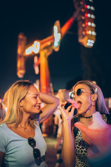 Two female friends having fun at the music festival