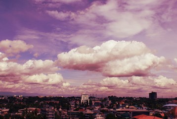 Crimson Sky with Storm clouds over city below