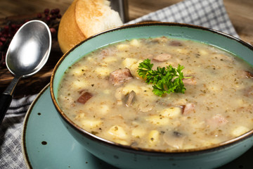 Traditional polish soup Zurek in ceramic bowl.