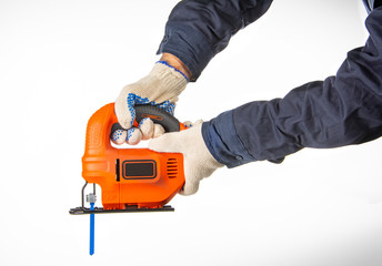 hands grabbing an orange grinder with safety elements